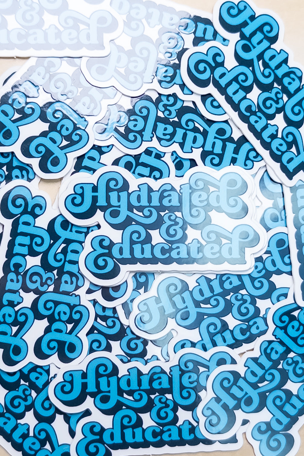 Hydrated & Educated Vinyl Sticker – 2" Retro Blue Quote Sticker – Waterproof Motivational Sticker for Laptop, or Water Bottle