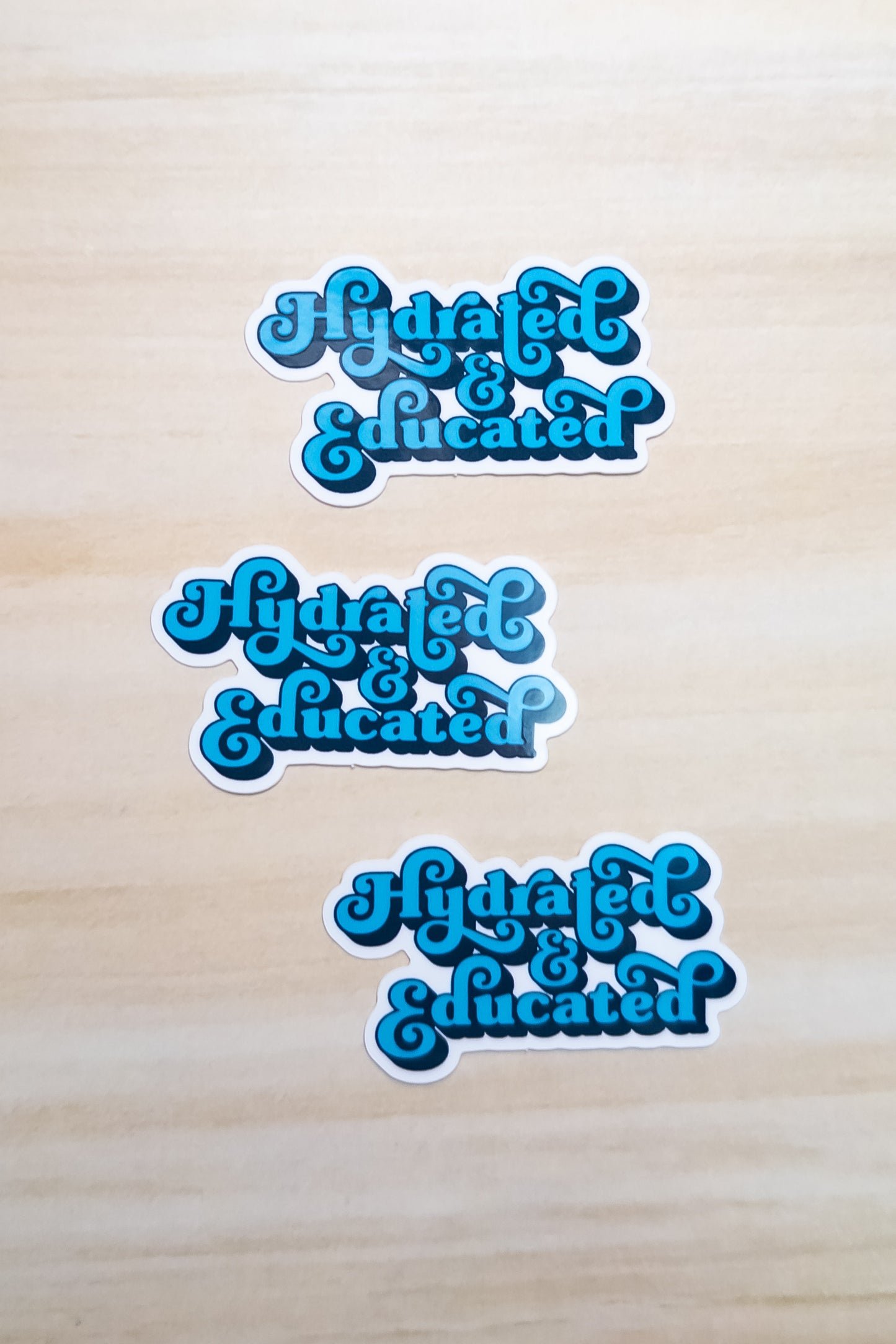 Hydrated & Educated Vinyl Sticker – 2" Retro Blue Quote Sticker – Waterproof Motivational Sticker for Laptop, or Water Bottle